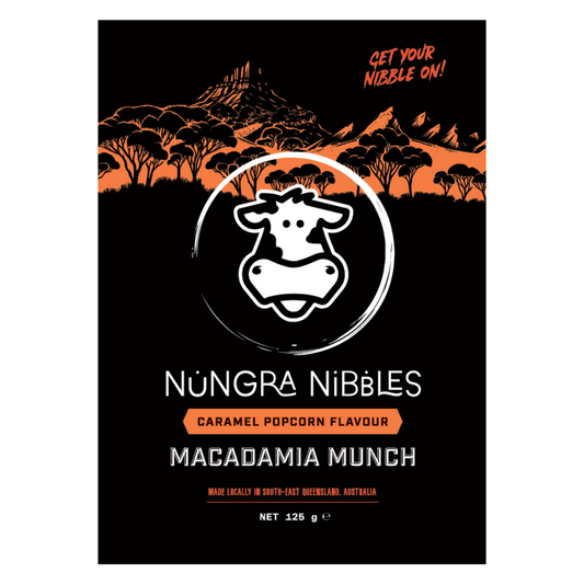 Nungra Nibbles macadamia munch packaging with a cow logo and scenic background.