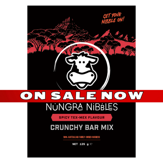 Nungra Nibbles Spicy Tex-Mex Flavour Crunchy Bar Mix packaging with a cow logo on a black background.